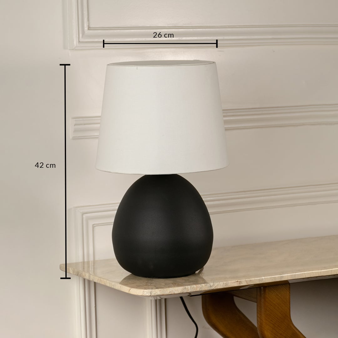 Black ceramic table lamp with white fabric shade measuring 42 cm height and 26 cm width for modern interior lighting.