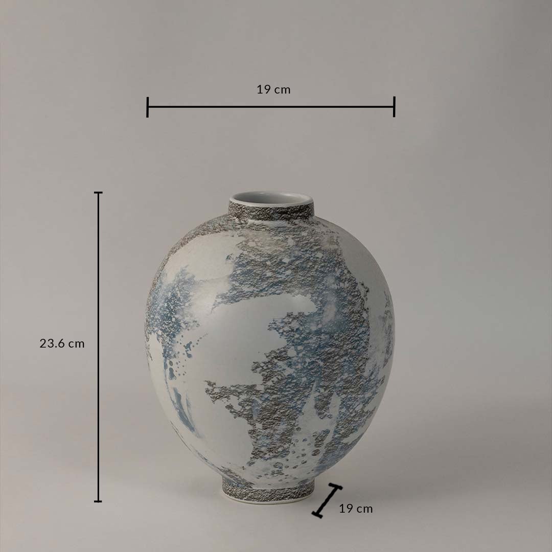 Contemporary ceramic vase with artistic grey and blue textured finish ideal for shelf or table styling on white background.