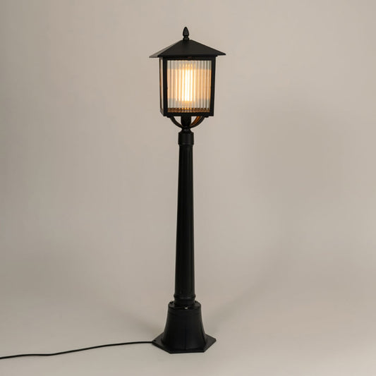 A classic outdoor lamp post with the light on against a clean white background highlighting its warm glow and refined lantern frame for clear product visibility.