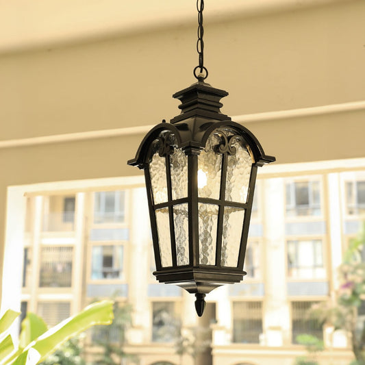 Vintage black metal hanging lantern light enhancing elegant balcony decor with warm ambient lighting.