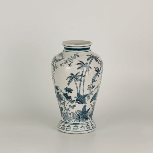 Blue and white ceramic jar featuring detailed landscape artwork with birds and trees shown on a plain surface creating a refined timeless decorative accent for interior spaces.