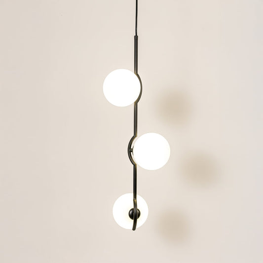 Elegant three-globe pendant light glowing softly on a clean white background featuring a sleek black frame and evenly spaced round shades.
