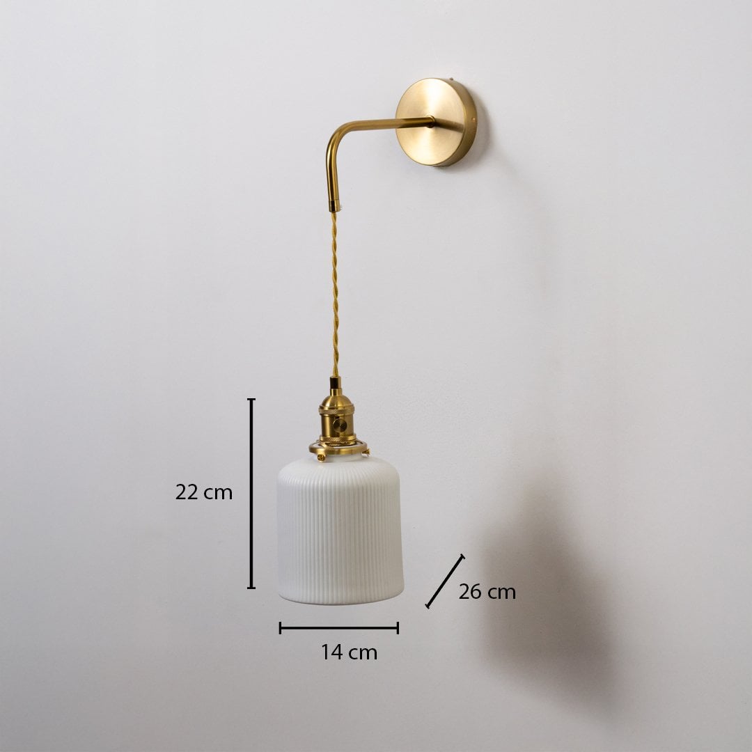 Gold wall light with ribbed cylinder shade shown with 22 cm shade height 14 cm width and 26 cm depth for accurate placement.