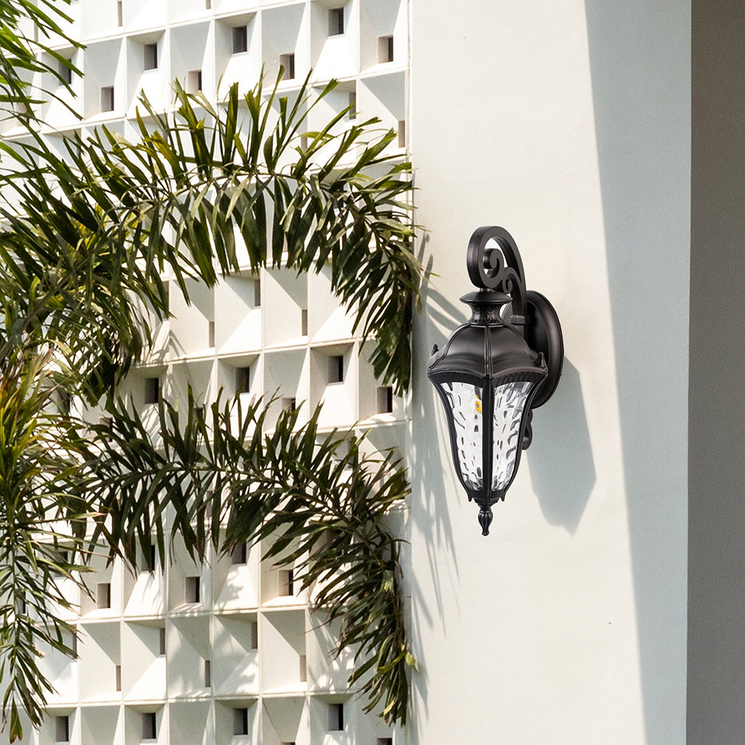 Antique lantern wall light mounted on an exterior wall creates a welcoming atmosphere for outdoor spaces.