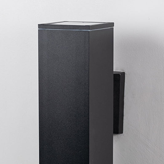 Closeup of rectangular black wall light featuring sleek lines and modern metallic texture with smooth edges.