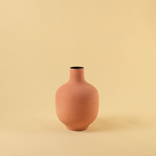 Elegant matte terracotta round vase for modern home decor and stylish minimalist shelf display accents.