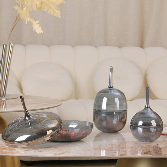 Modern grey glass jar set with tall lids styled on marble table adding elegance to luxury living room home decor.