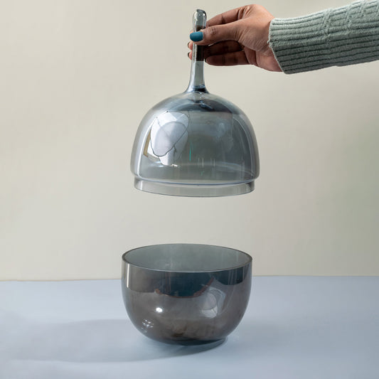Smoke grey glass decorative bowl with matching glass lid showcased for contemporary tabletop styling and home decor.