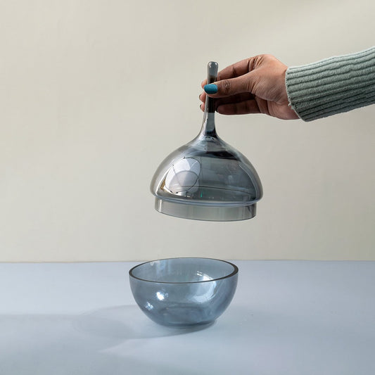 Blue glass decorative bowl with matching lid displayed for elegant modern tabletop styling and home decor.