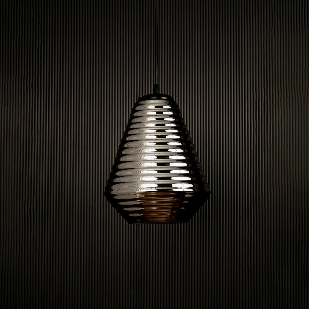 Smoked ribbed glass pendant light displayed on dark background with light off highlighting its elegant form and premium finish.