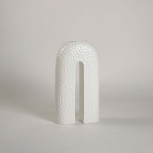 Elegant U-shaped ceramic vase in white finish displayed on plain white background with refined handcrafted texture.