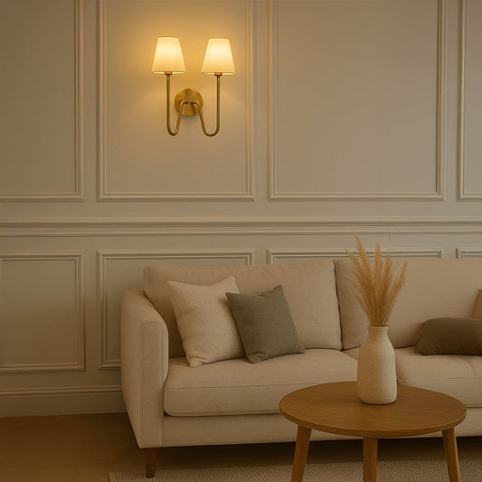 Modern double wall light with gold metal frame and twin white shades adding warm style to bedroom hallway or living space decor.