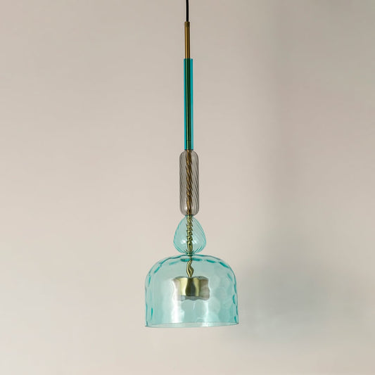 Blue hammered glass pendant light with green accents designed for stylish modern home interiors.