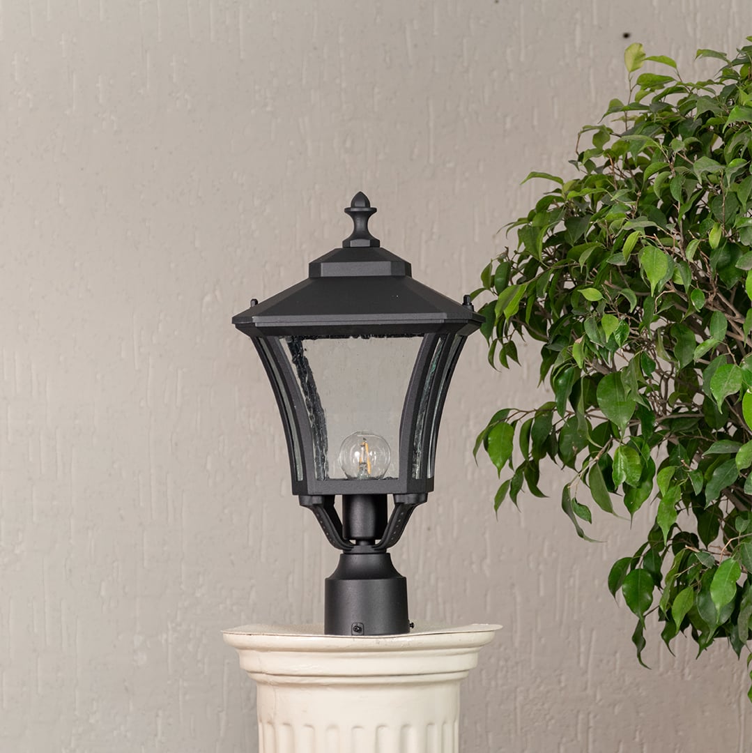 Outdoor black pillar lantern with clear glass and sturdy base shown unlit ideal for pathways garden posts and exterior decor.