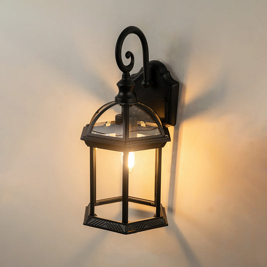 Black metal outdoor wall light on white background featuring an elegant arched frame and clear glass for patio decor.