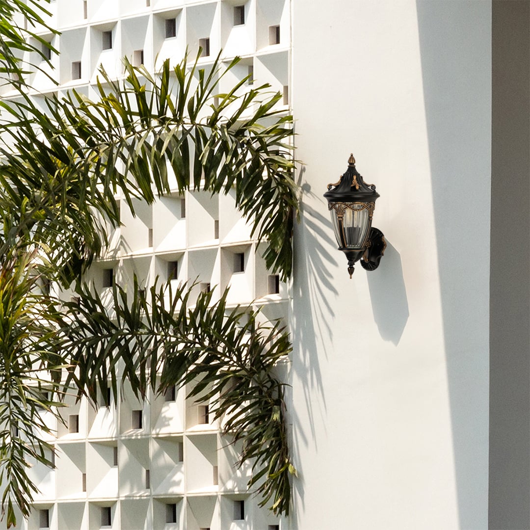 Bronze outdoor lantern with the light off fixed on a bright exterior wall showcasing its ornate vintage frame and ribbed glass design for classic outdoor decor.
