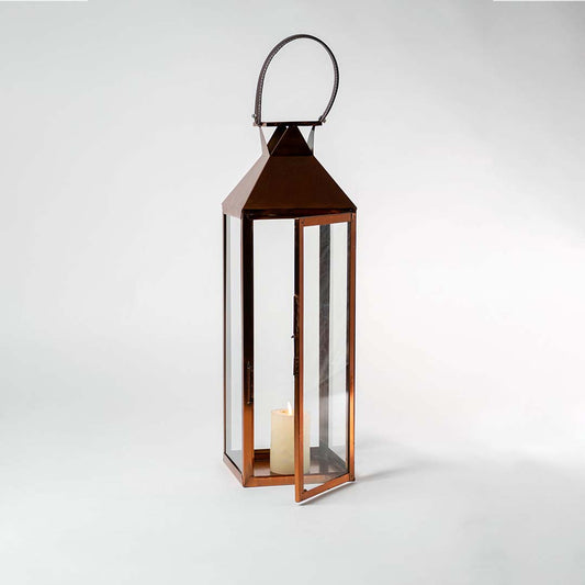 Brown metal lantern with clear glass panels displayed on white background for stylish modern home decor accent.