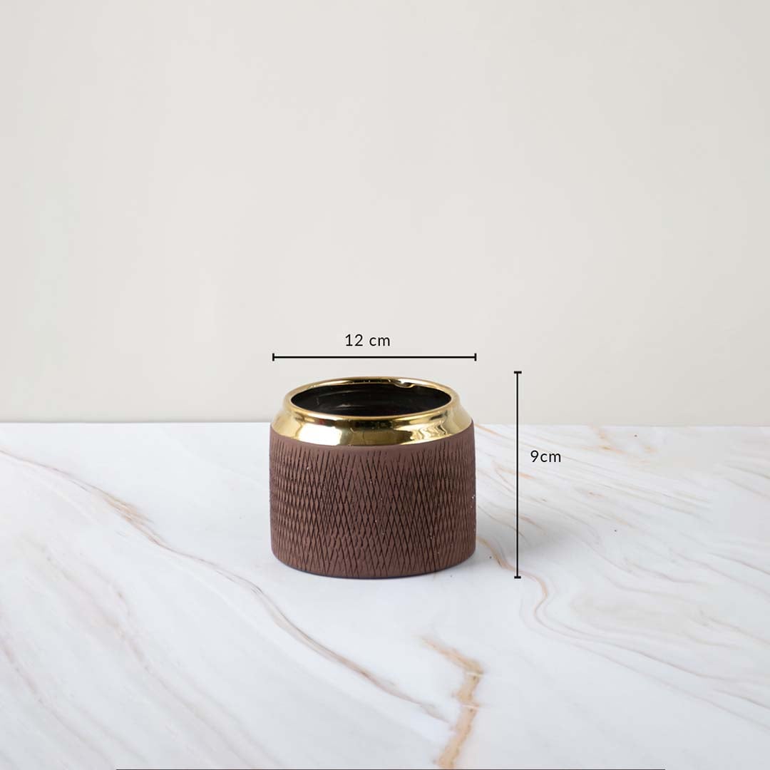A brown textured vase with a gold rim shown with measurements of 12 cm width and 9 cm height clearly displaying its compact decorative size.