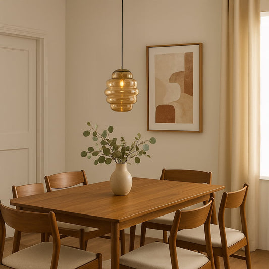 Amber ripple pendant light hanging above wooden dining table adding warm glow and modern elegance to cozy interiors.