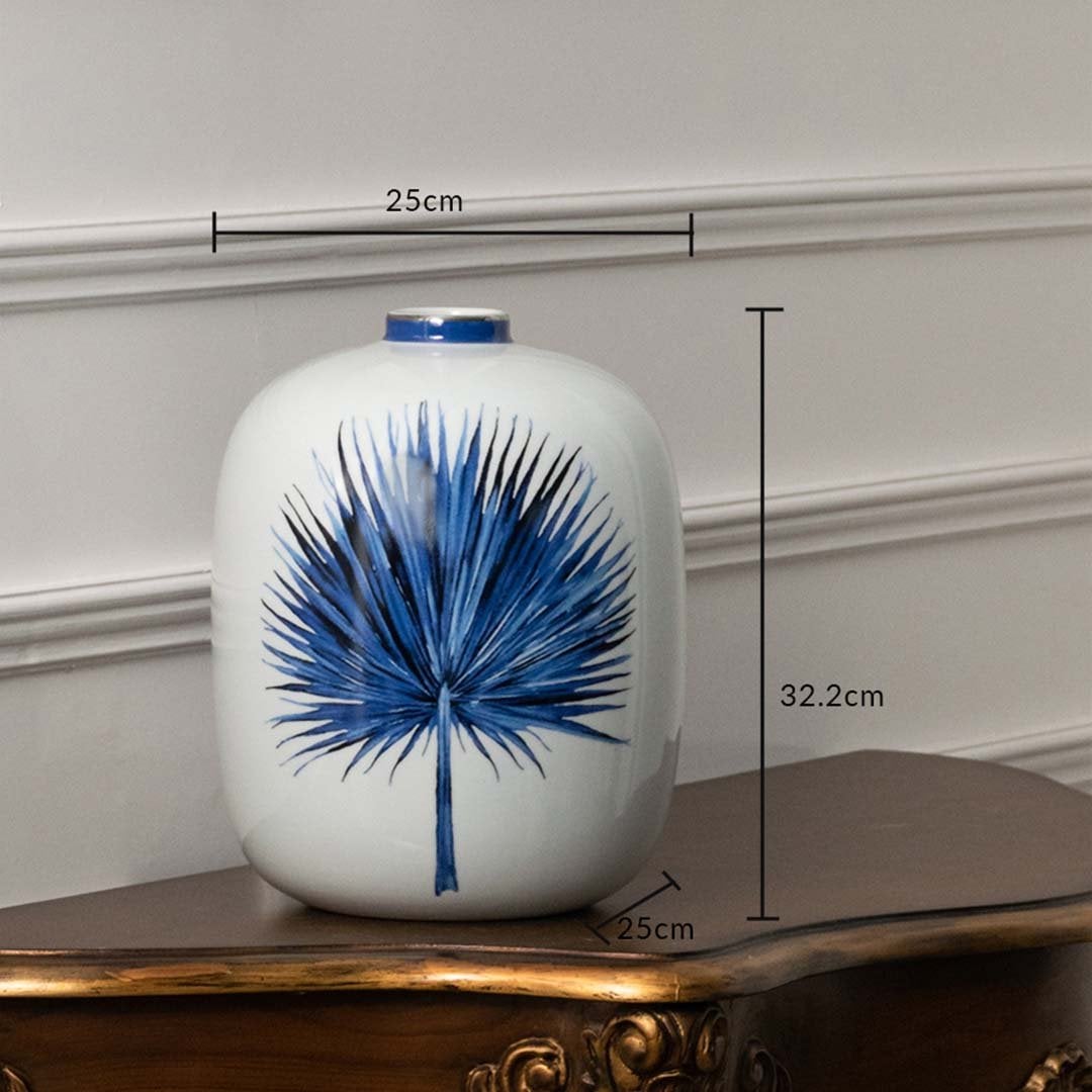 White ceramic jar with blue leaf artwork measuring 20 cm width and 26.5 cm height ideal for contemporary console décor and stylish home accents.