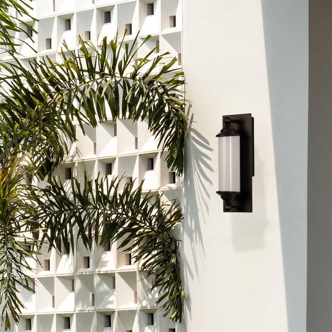 Elegant black metal wall light with frosted glass shade adding warm ambient lighting to modern living spaces.
