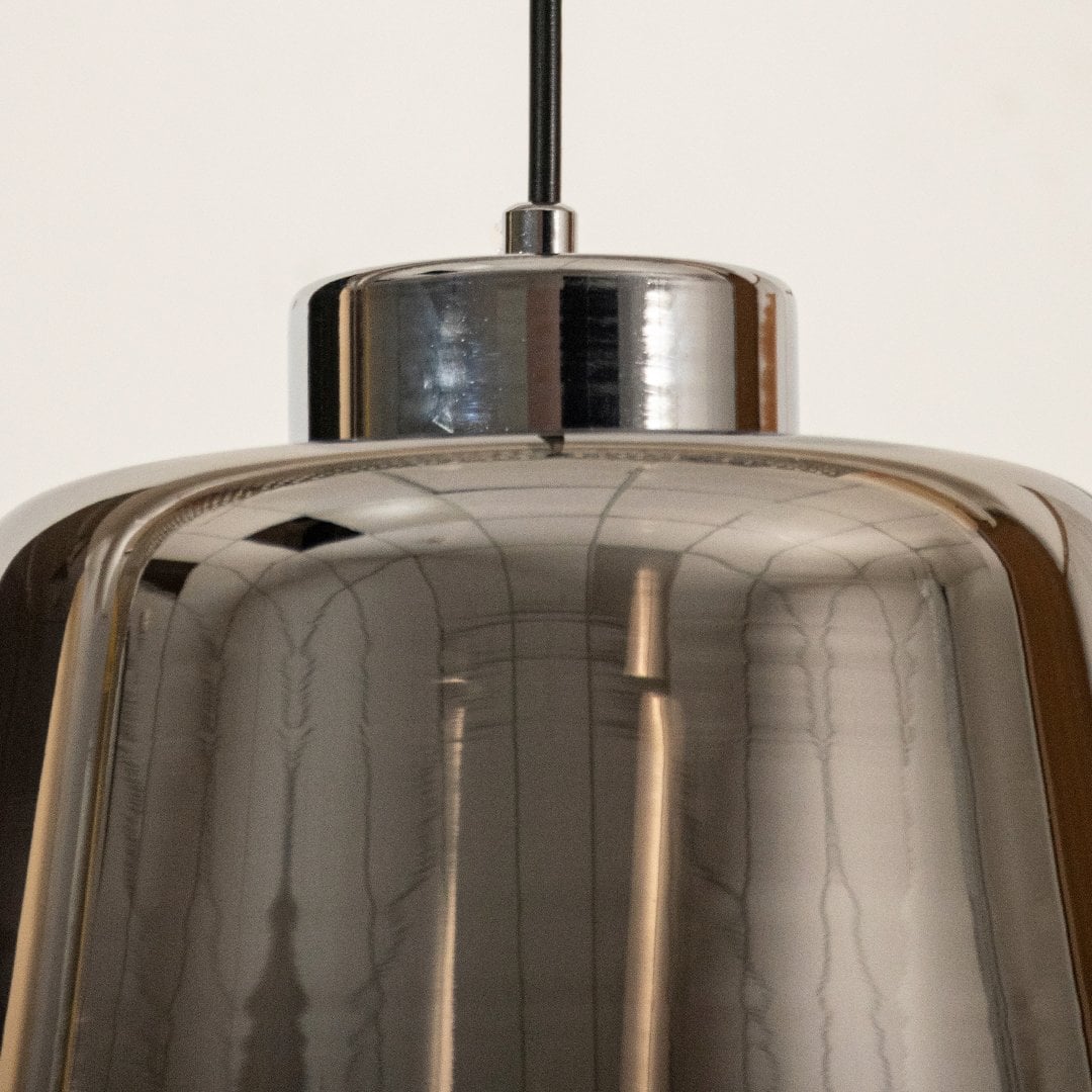 Closeup of smoked grey glass pendant light showing its reflective surface and modern tapered design ideal for stylish contemporary decor.