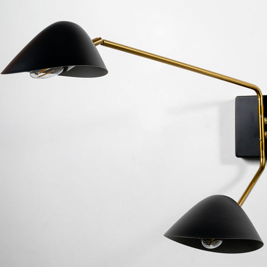 Modern black and gold metal wall light for stylish bedroom and contemporary decor styling spaces.