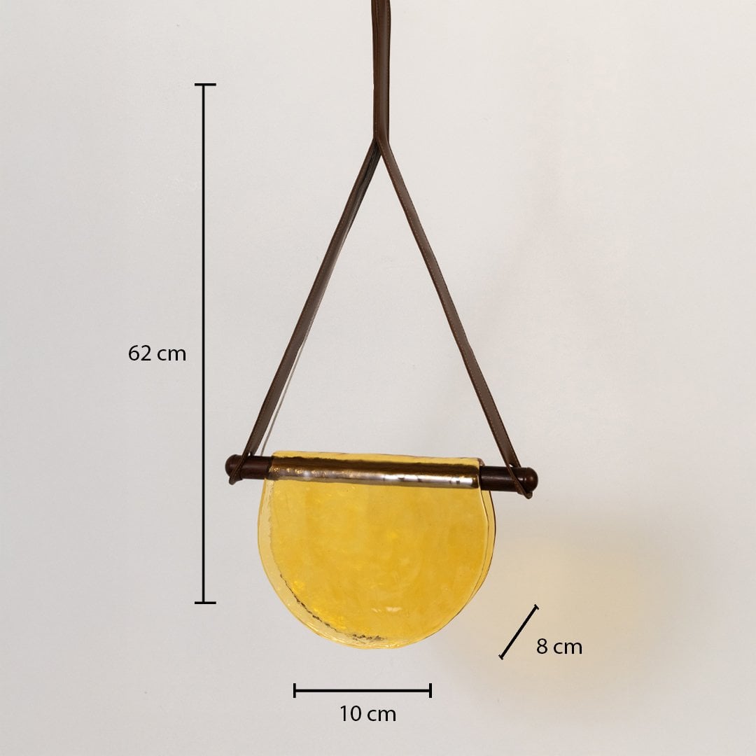 Pendant light with labeled measurements showing 62 cm height 10 cm width and 8 cm depth featuring a yellow half-moon glass shade.