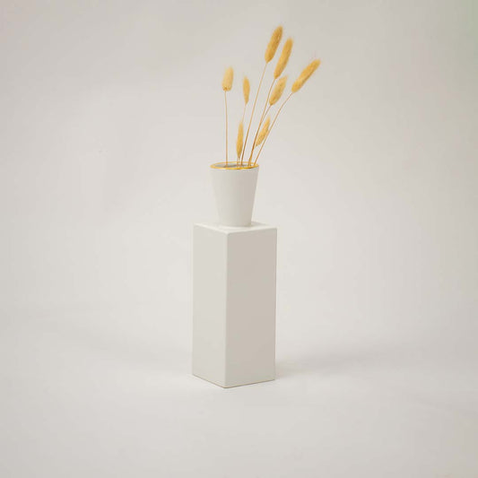 White ceramic vase with gold rim styled in a modern interior perfect for shelves tables and elegant contemporary home decor.