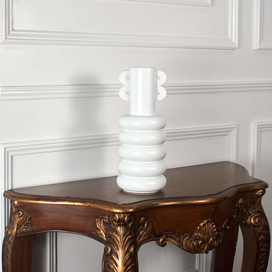 Modern white ceramic vase with sculpted rings and loop handle shown on a clean bright white background for stylish home decor.