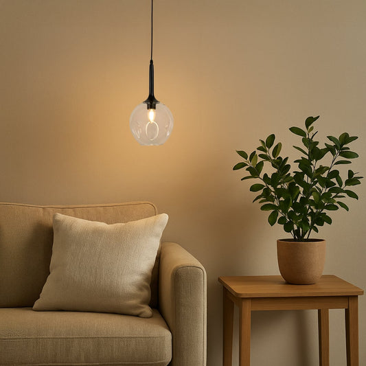 Stylish glass pendant light adding soft illumination to a balcony corner with chair and plant decor.