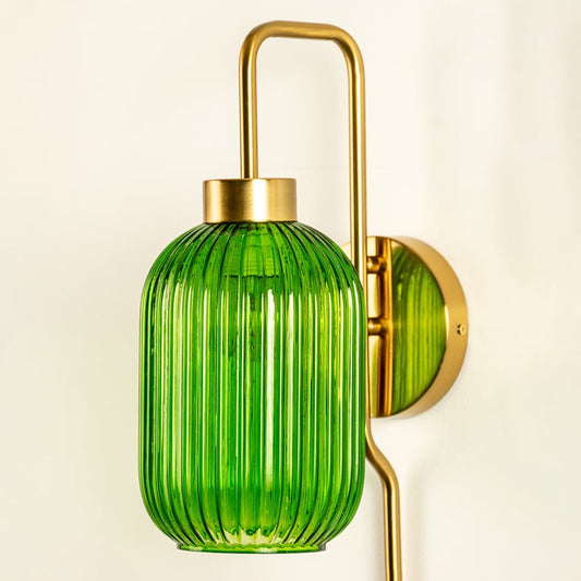 Closeup view of green ribbed glass wall sconce showing its detailed vertical texture and long smooth metal rod ideal for refined modern interior home decor lighting.