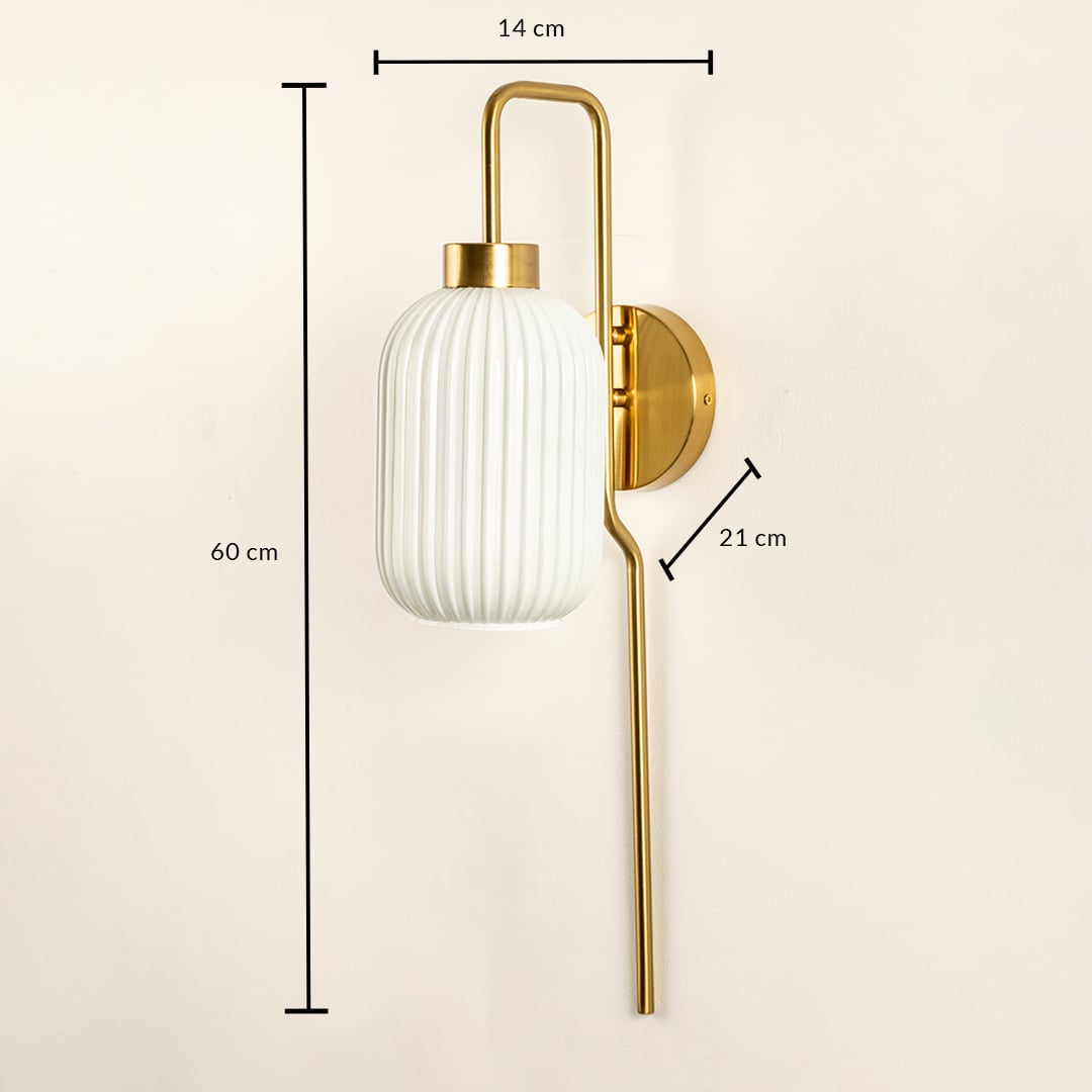 Gold metal wall light with white ribbed glass shade measuring 60 cm height 21 cm projection and 14 cm width.