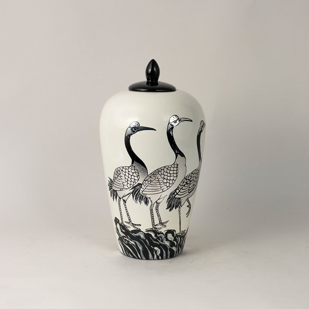 Glossy white ceramic jar with black crane motif and smooth finish ideal for modern and traditional home styling.