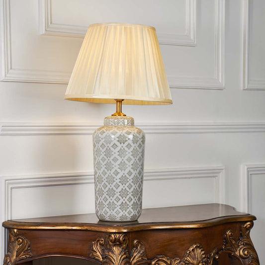 Grey patterned ceramic table lamp with pleated fabric shade designed for timeless traditional decor and ambient lighting.