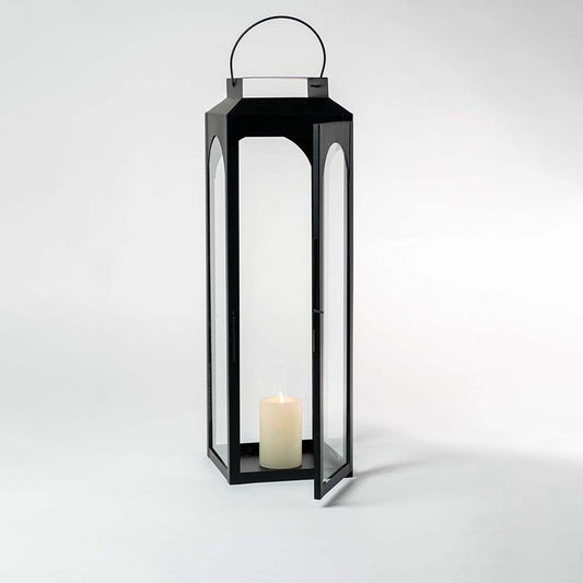 Black lantern photographed on a bright white background emphasizing its clean lines and glossy finish.
