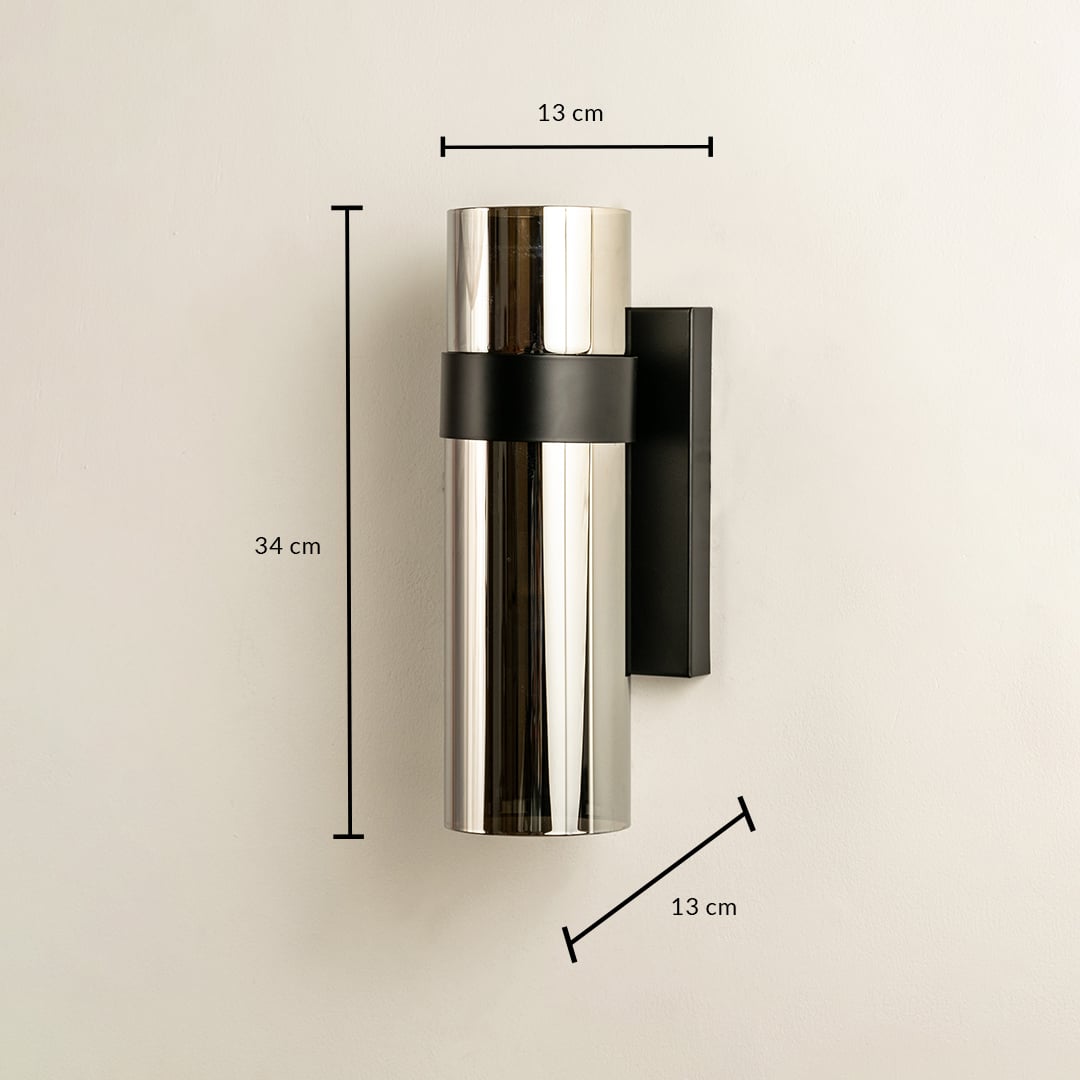 Sleek silver and black cylindrical wall light shown with height 30 cm width 10 cm and depth 12 cm ideal for modern exterior and interior décor lighting.