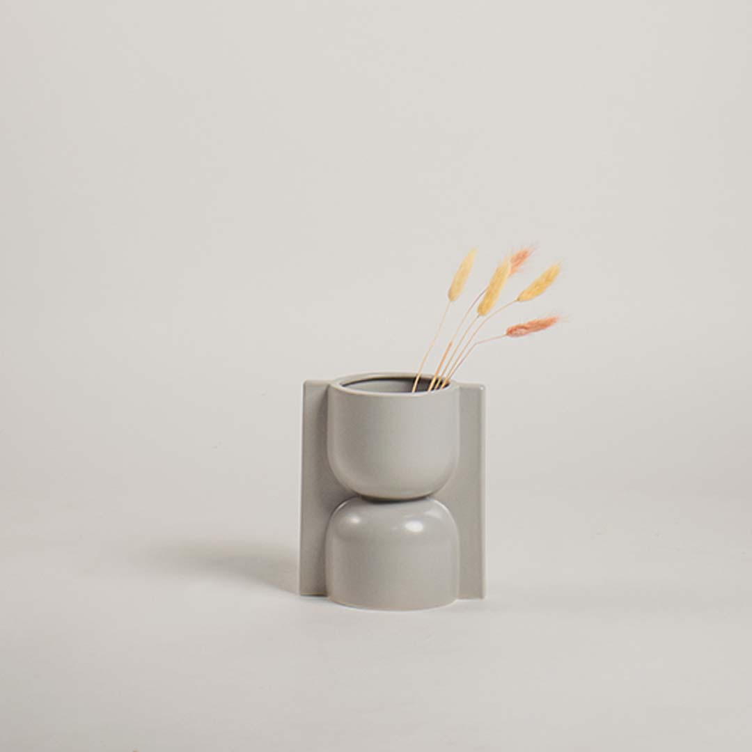 Modern light grey ceramic vase with sculptural geometric design shown on a plain white background perfect for refined minimal styling.