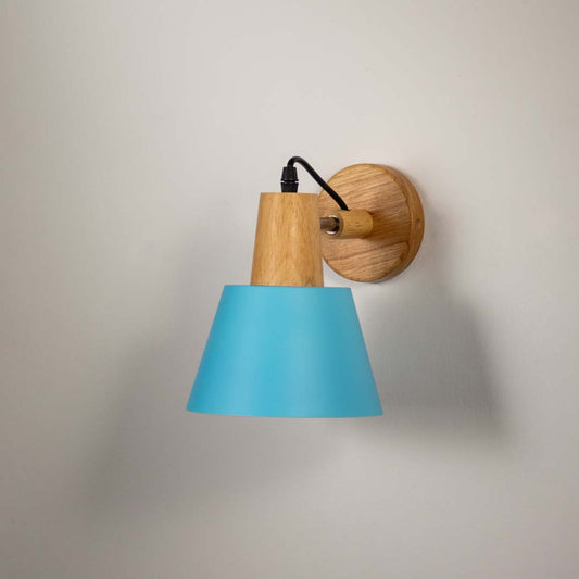 Modern wall sconce with matte sky blue shade wooden base and black cord ideal for bedroom living room and hallway walls.