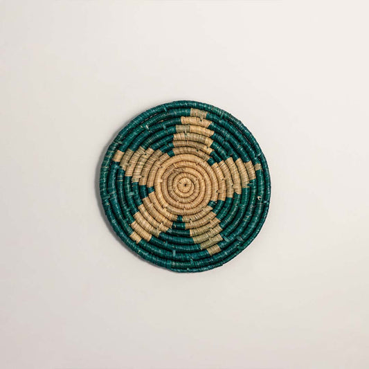 Green and natural handcrafted woven wall basket with floral motif for artistic wall styling and contemporary home decor.