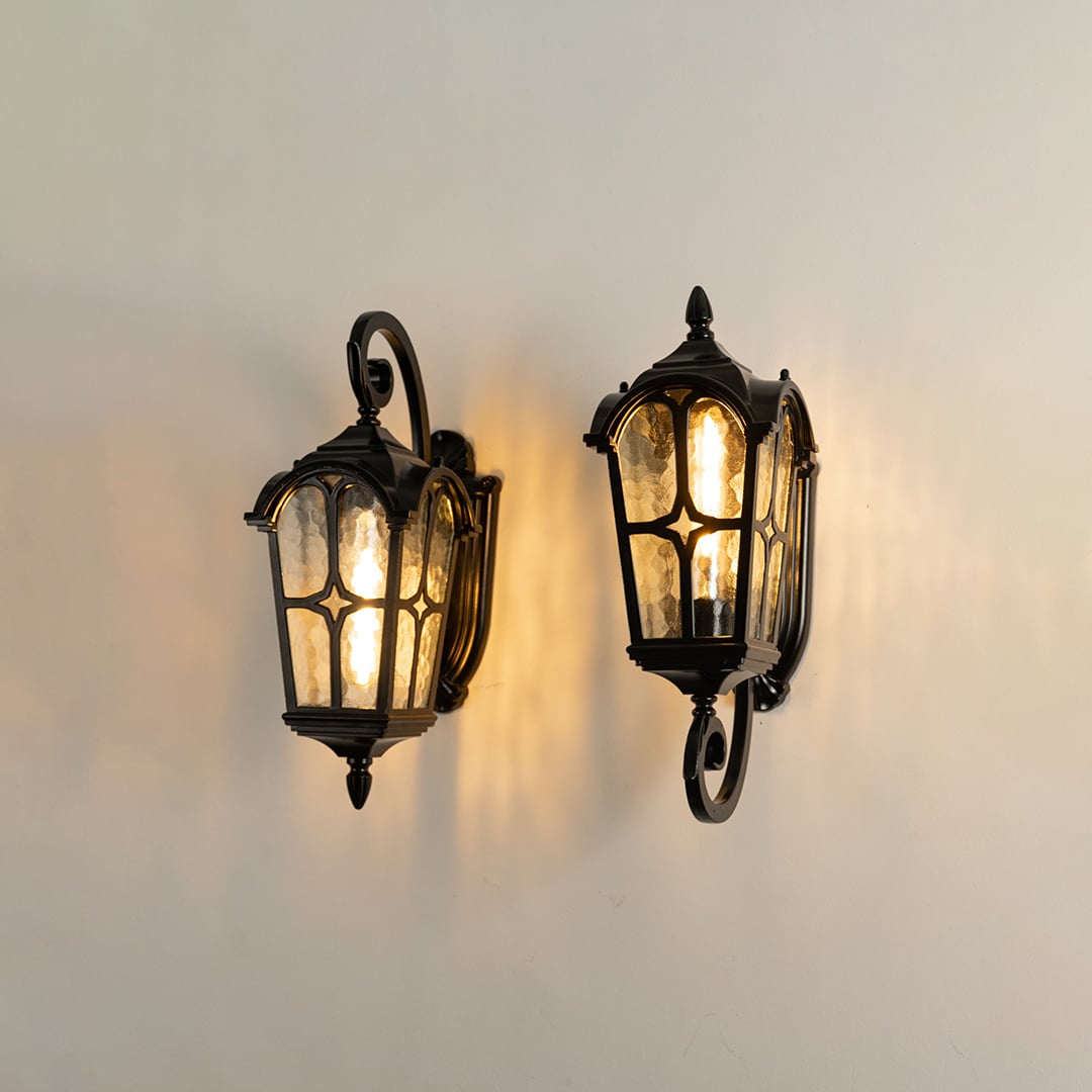 Black outdoor lantern shown as part of a grouped product display highlighting its classic design.