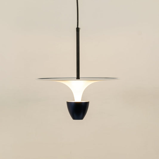 White and black metal pendant light illuminated to showcase sleek modern ceiling lighting with balanced elegance.