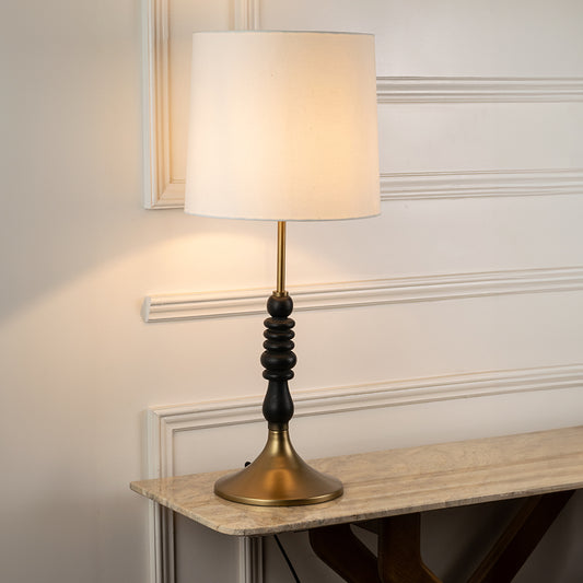Table lamp with white fabric shade and black metal base perfect for bedroom or living room table decor styling on clean background.