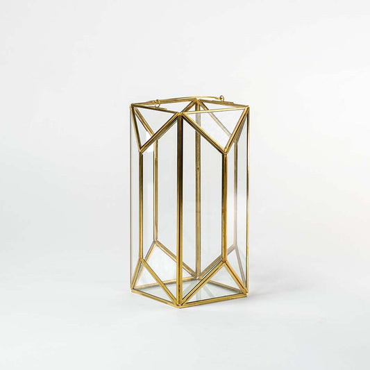 Gold metal geometric candle holder with open frame design for luxury tabletop decor styling use.