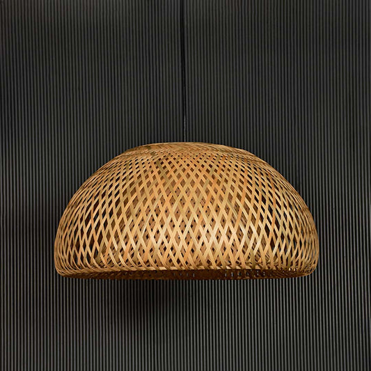 Handwoven rattan pendant light with natural finish glowing for warm organic interiors.