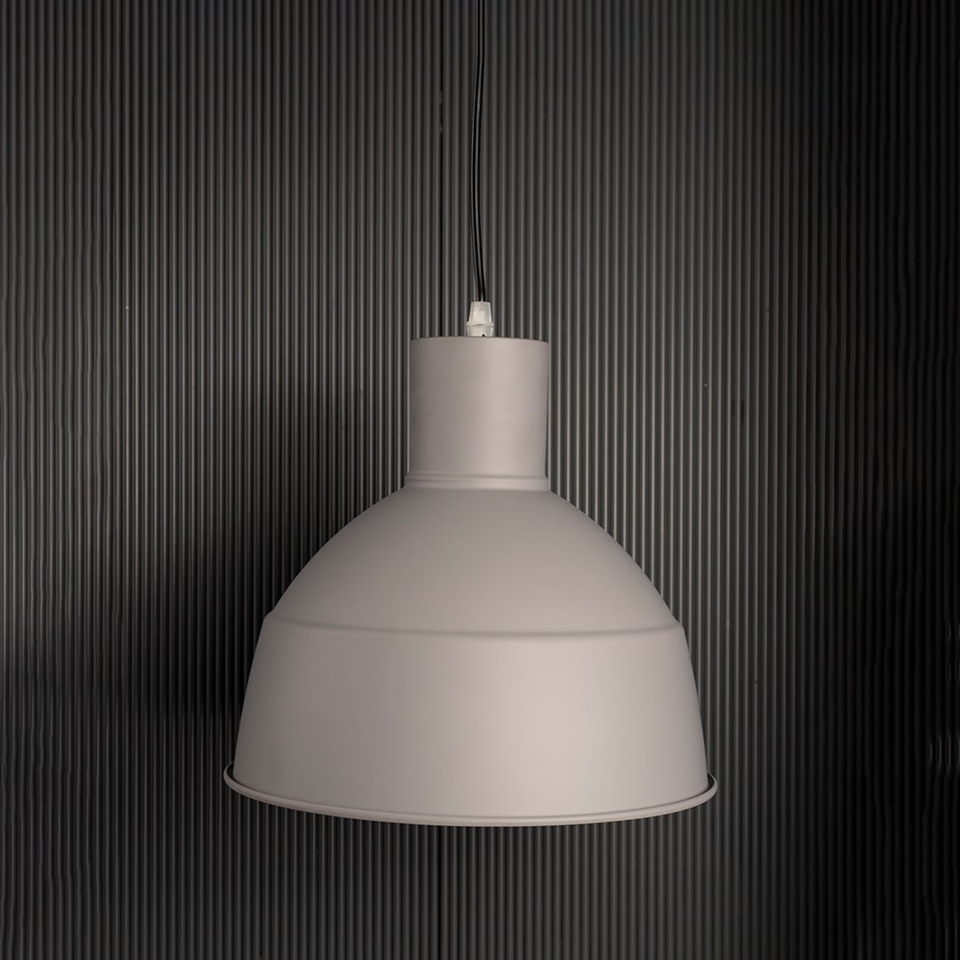 Grey pendant light with light off on white background featuring industrial-inspired dome shade.