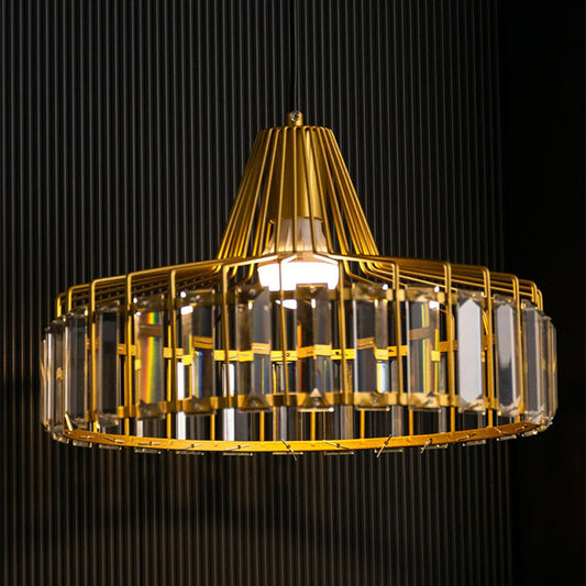 Crystal glass chandelier with gold metal frame illuminated for luxurious contemporary interiors.