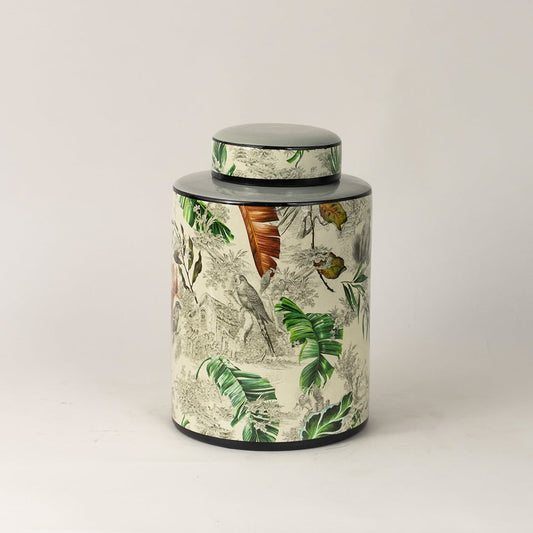 Tropical bird jar captured from side angle showing curved body and detailed bird and leaf artwork.