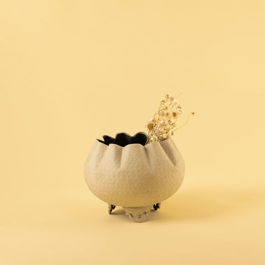 Cream metal scalloped bowl planter decor styled in a warm modern room adding an elegant accent to living room tables and corners.