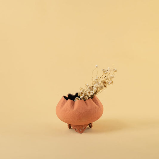 Terracotta metal scalloped bowl planter decor styled in a warm modern room adding an earthy elegant accent to living room tables.